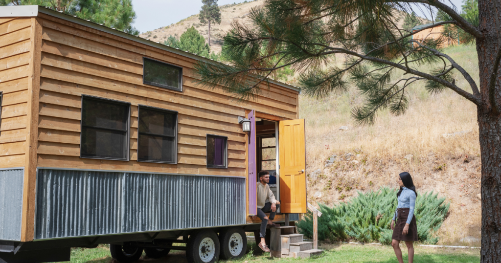 young couple outside their tiny house